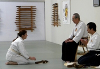 Karen Sensei receiving Jo-Kyu certificate (brown belt) from Soshi Okamoto of Roppokai (Fremont CA Sep 2009)